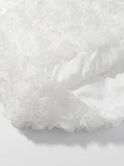 Close-up of white tulle fabric on a light gray background