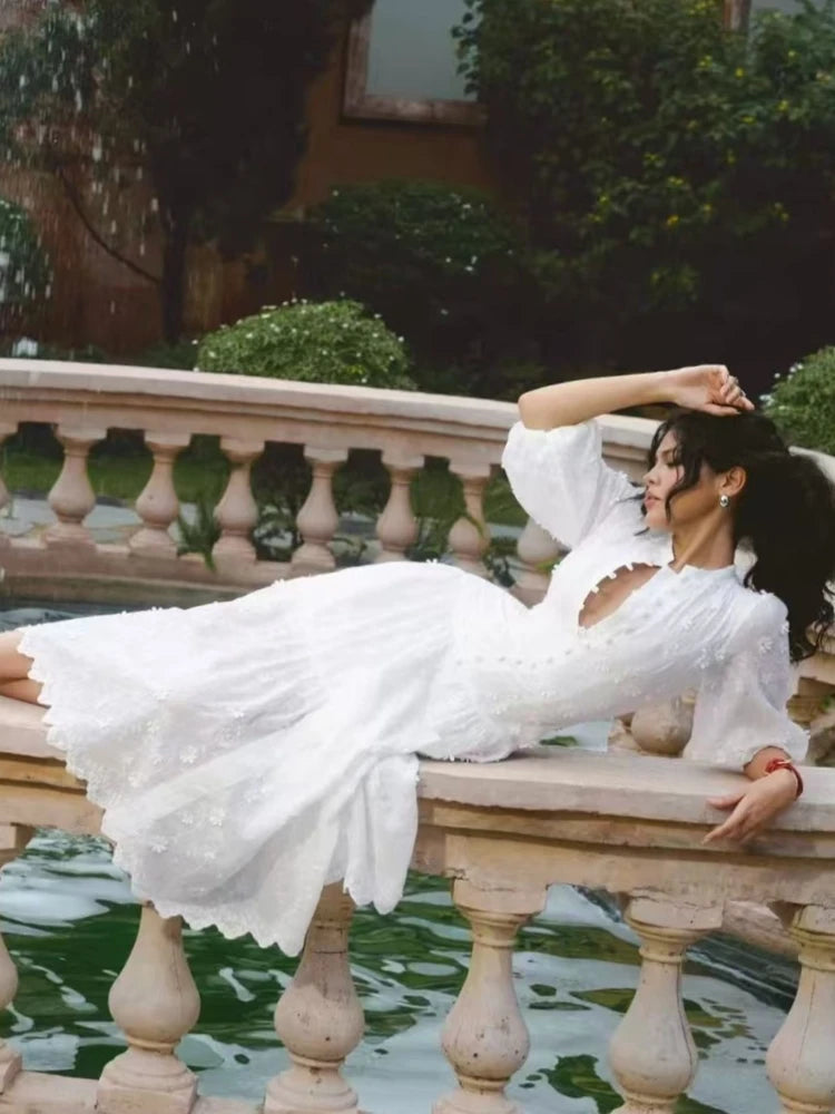 White embroidered puff sleeve midi dress lying down