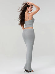 Woman wearing a gray two-piece outfit on a white background