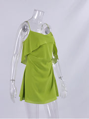 Green dress on a mannequin against a white background