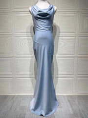Long light blue evening gown on a mannequin against a white paneled wall.
