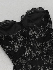 Black floral embroidered dress on a light gray background