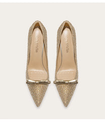 Gold glittery pointed-toe shoes with bow detail on a white background