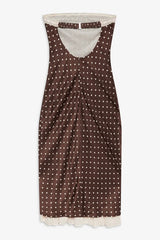 Brown polka dot dress with white trim on a white background