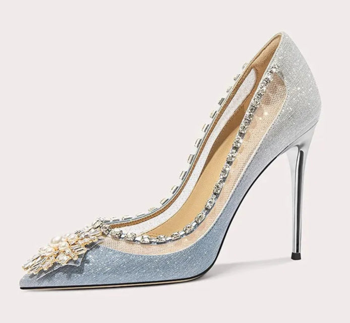 High-heeled shoe with decorative elements on a light gray background
