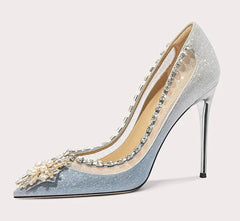 High-heeled shoe with decorative elements on a light gray background