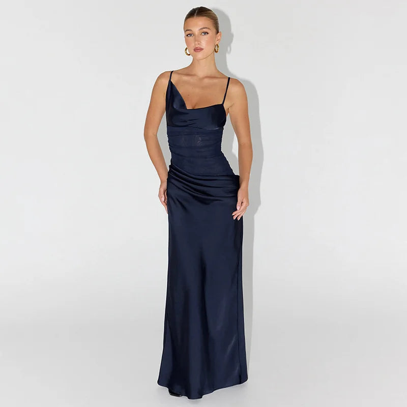 Woman wearing a navy blue evening gown against a white background