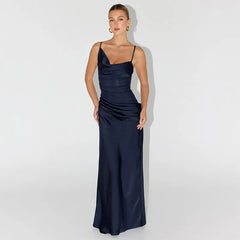 Woman wearing a navy blue evening gown against a white background