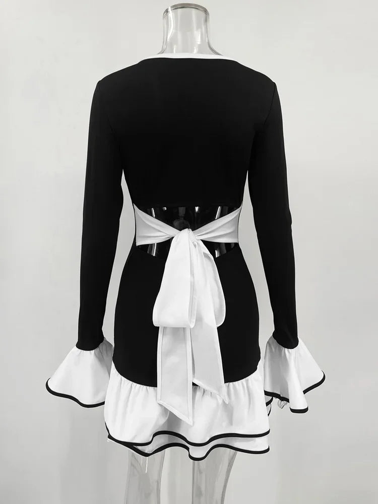 Black dress with white apron on a mannequin against a white background