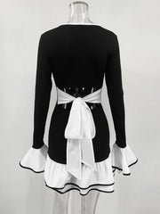 Black dress with white apron on a mannequin against a white background
