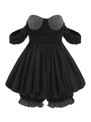 Black dress with embellished collar and hem on a white background