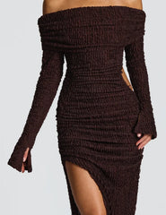 Brown ribbed knit dress with long sleeves and a high slit on a light gray background