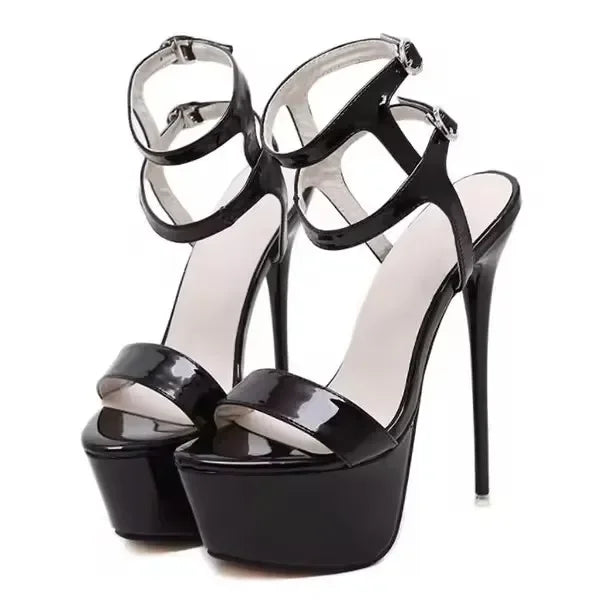 Black high-heeled platform sandals on a white background