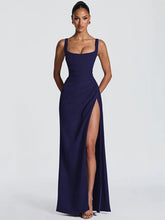 Navy blue evening gown with a high slit on a white background