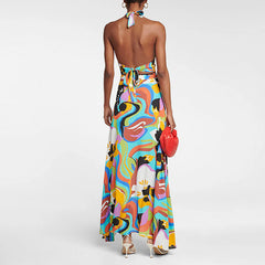 Back view of vibrant abstract print two-piece halter top and maxi skirt swimwear set