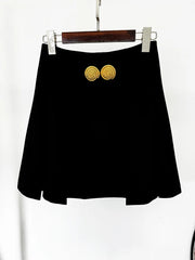Black pleated mini skirt hanging on a hanger