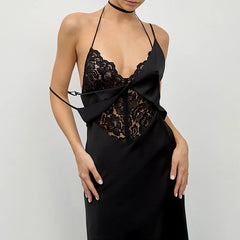 Black lace dress with a bow detail on a plain background