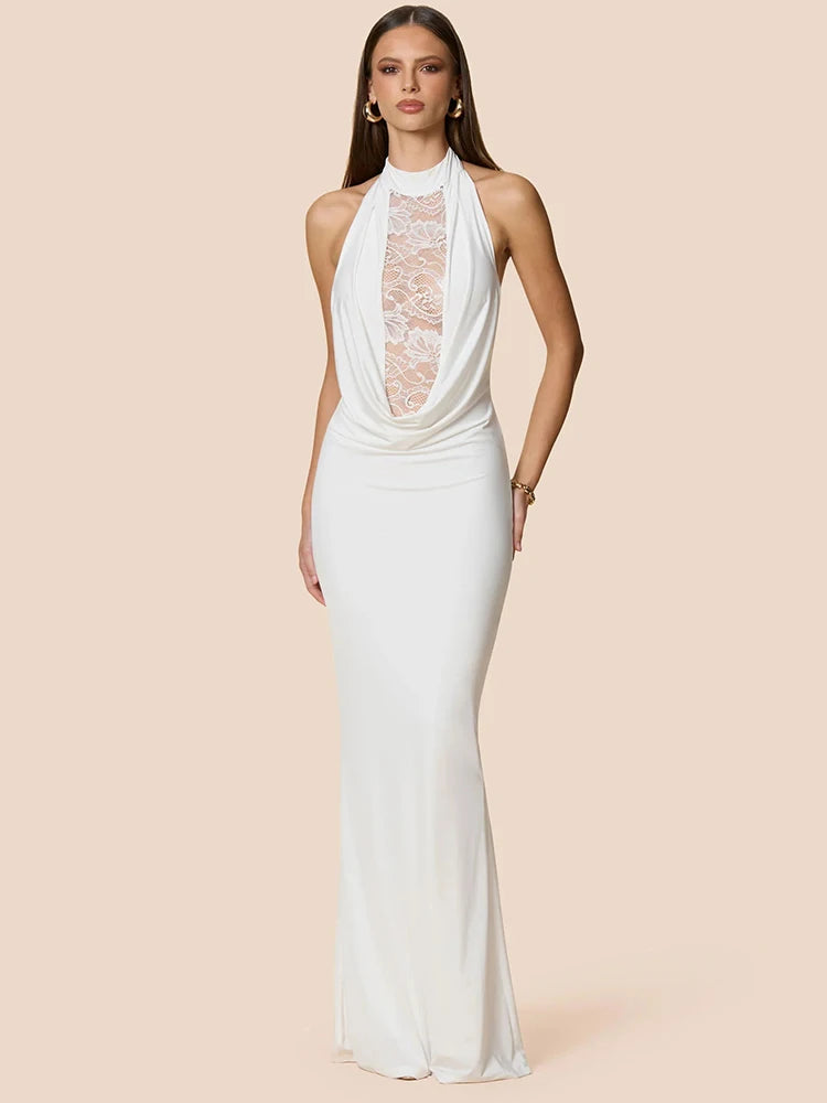 Woman wearing a white halter neck gown with lace detailing on a beige background