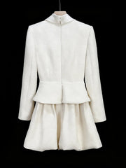White jacket and skirt set on a black background