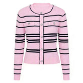Pink striped button-up knit cardigan with black trim and embellished buttons.