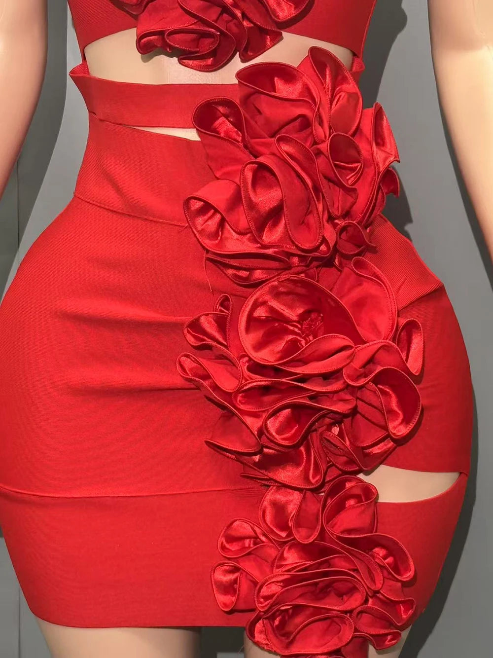 Red dress with floral embellishments on a gray background