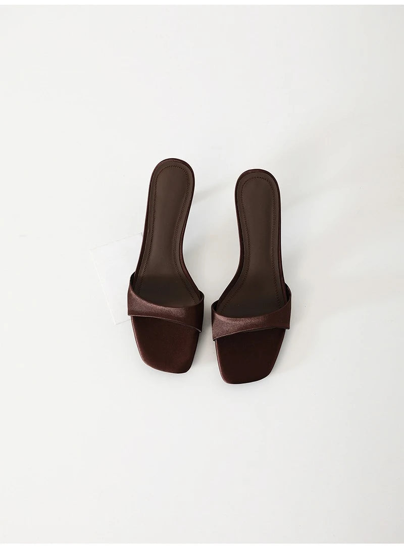 Pair of brown sandals on a white background