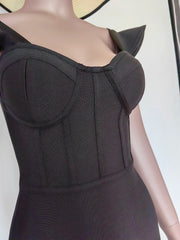Black dress on a mannequin with a plain background