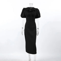 Black dress on a mannequin against a white background