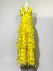 Yellow polka dot dress on a mannequin against a white background