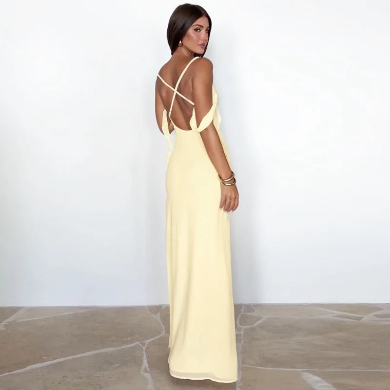 Woman wearing a light yellow dress with thin straps on a white background