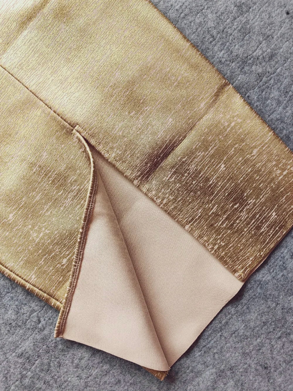 Folded fabric with a gradient color pattern on a textured surface