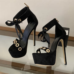 Black platform stiletto lace-up sandals with metal eyelets and ribbon ties.