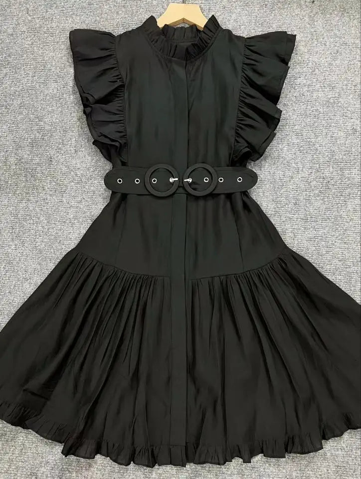 Black dress with ruffled sleeves and a belt on a gray background