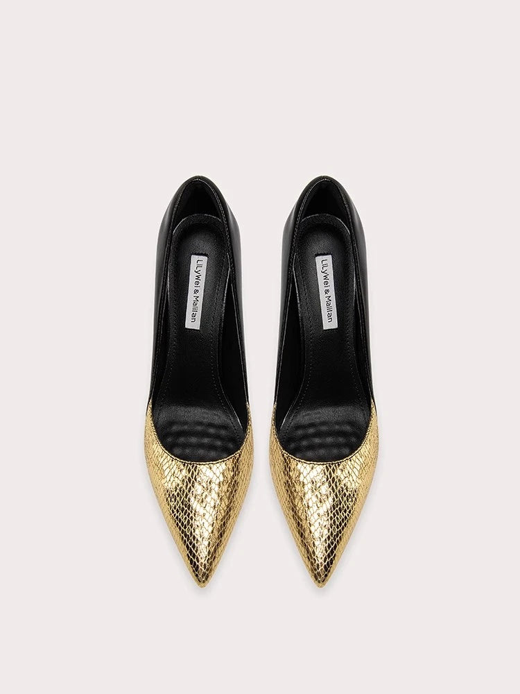 Gold pointed-toe shoes with black soles on a light gray background