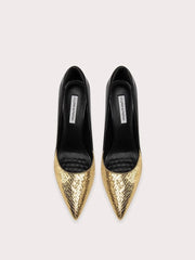 Gold pointed-toe shoes with black soles on a light gray background