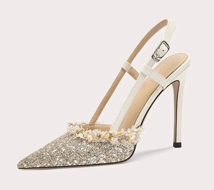 High-heeled shoe with decorative sole on a white background