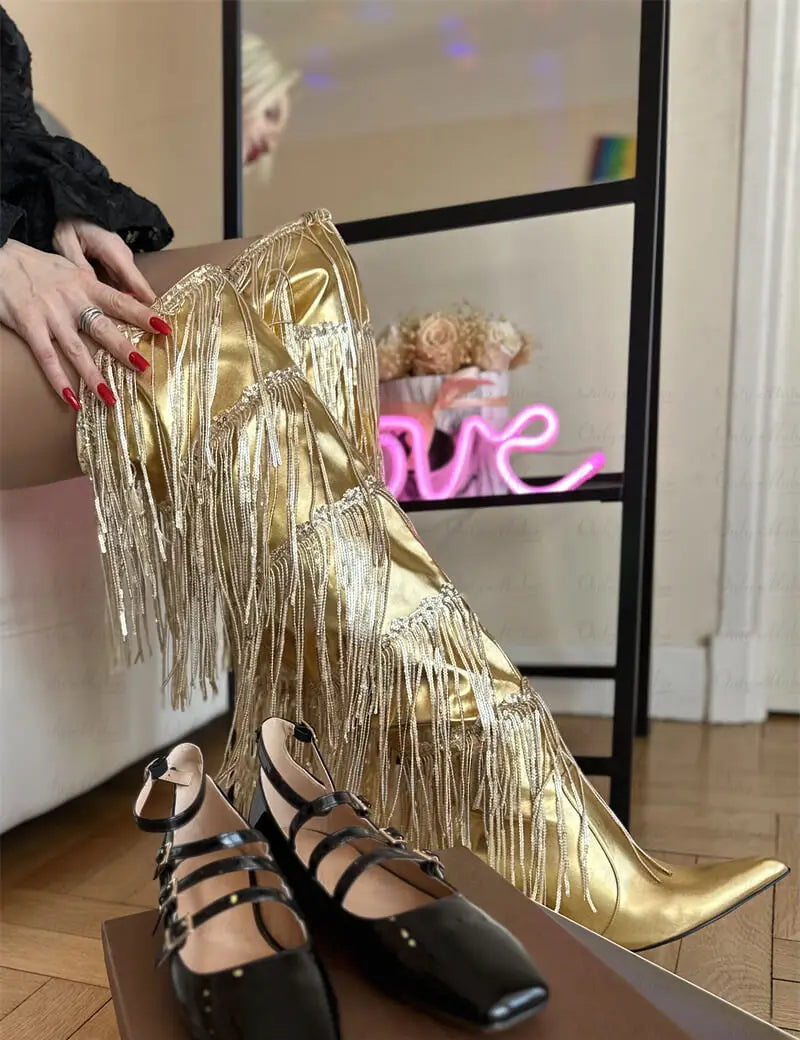 Close-up of metallic fringe over the knee boots