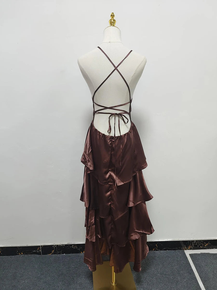 Brown dress with ruffled skirt on a mannequin against a plain background