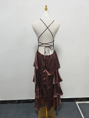 Brown dress with ruffled skirt on a mannequin against a plain background