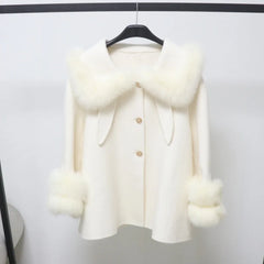 White coat with fur trim on a hanger against a white background