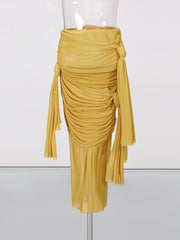 Mustard yellow draped skirt on a mannequin against a white background