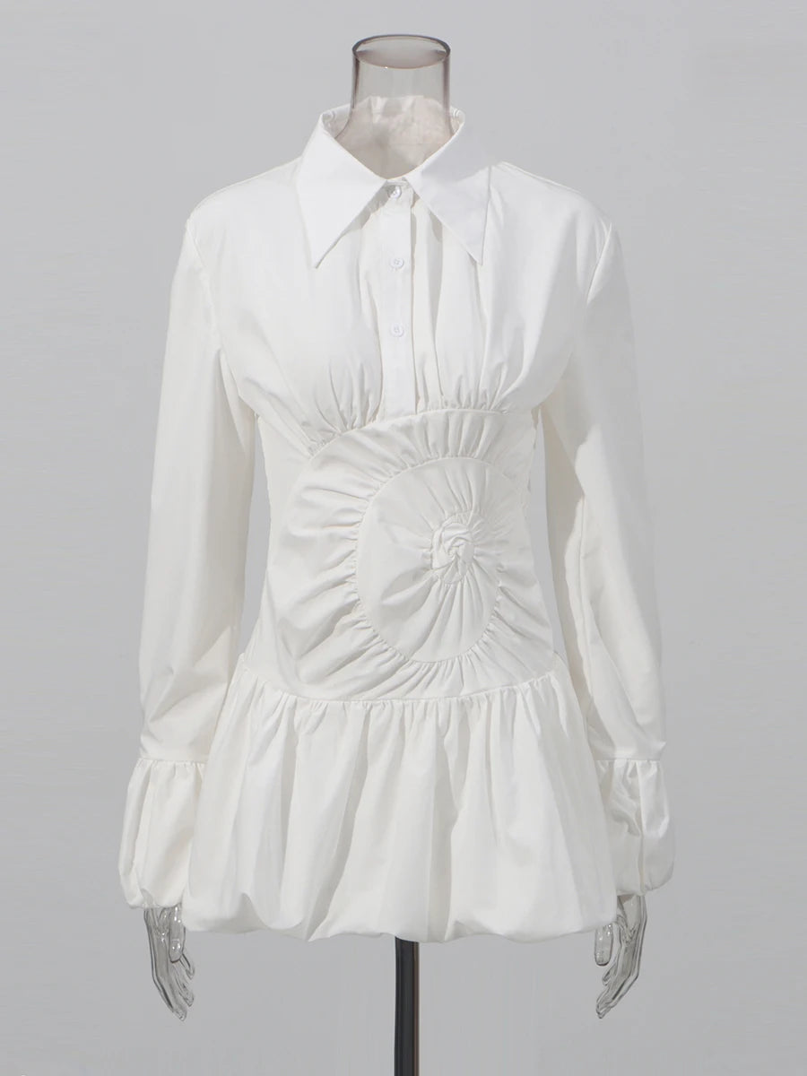 White blouse on a mannequin against a gray background