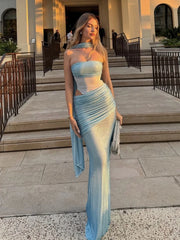 Woman in a light blue strapless gown standing outdoors on steps.