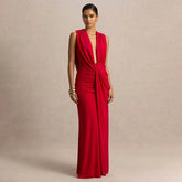 Woman wearing a red gown against a beige background