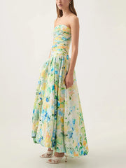 Woman wearing a strapless floral dress on a white background