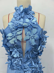 Blue floral dress on a mannequin against a white background