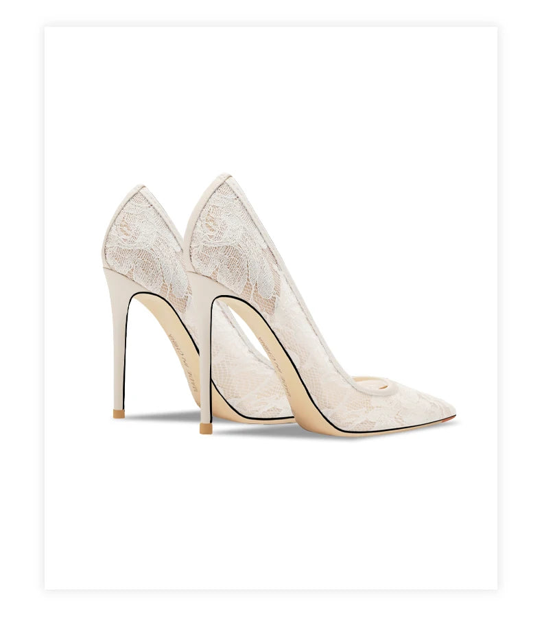 Pair of high-heeled shoes with lace detailing on a white background
