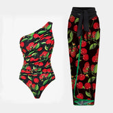One-shoulder ruched swimsuit with cherry print and matching wrap skirt cover-up.
