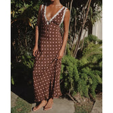 Polka dot maxi dress with lace trim and tie-back detail.