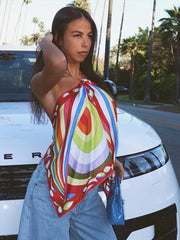 Psychedelic print halter top and denim wide-leg pants.